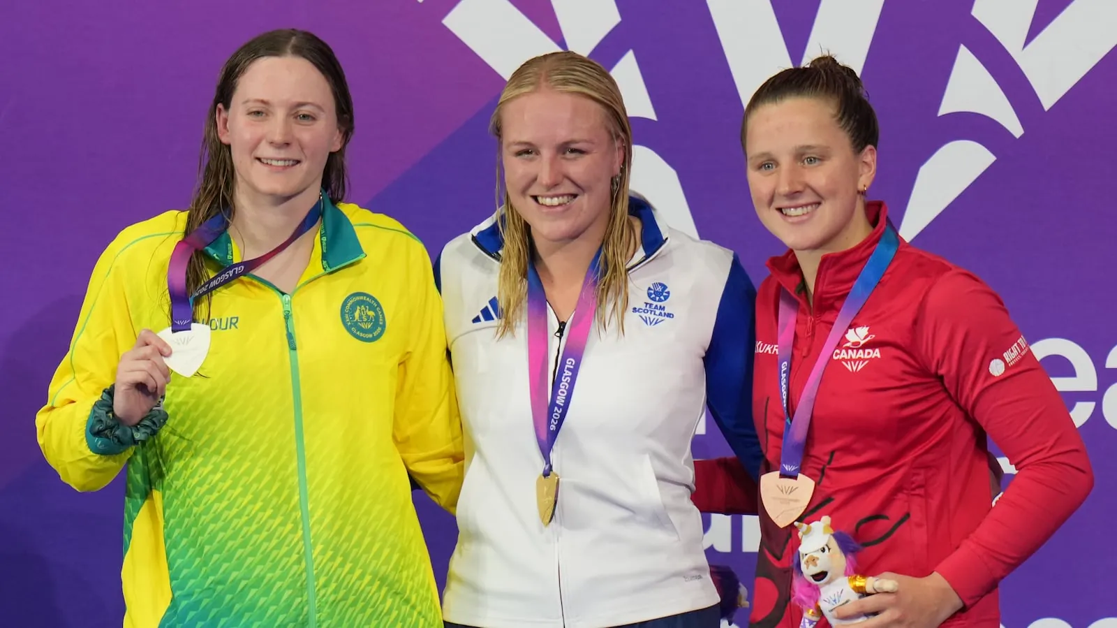 Faye Rogers of Scotland, center, gold medal, with Jasmine Greenwood of Australia, silver, left, and Mary Jibb of England, bronze, pose on the podium during the medal ceremony for the women's 200 meter individual medley SM10 swimming event during the Commonwealth Games in Glasgow, Scotland, Friday, July 24, 2026. (AP Photo/Kin Cheung)(Kin Cheung/AP Photo/Kin Cheung)