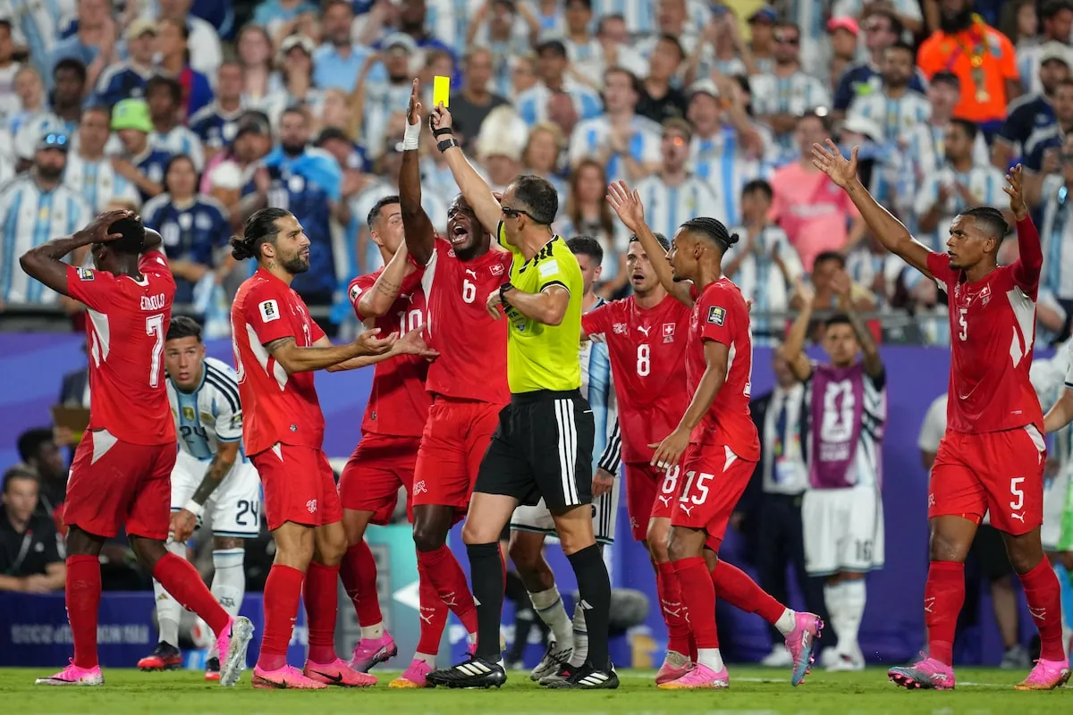 Switzerland's players argue referee Joao Pinheiro, of Portugal, gives a second yellow card to Breel Embolo during the World Cup quarterfinal soccer match between Argentina and Switzerland.Ed Zurga/The Associated Press