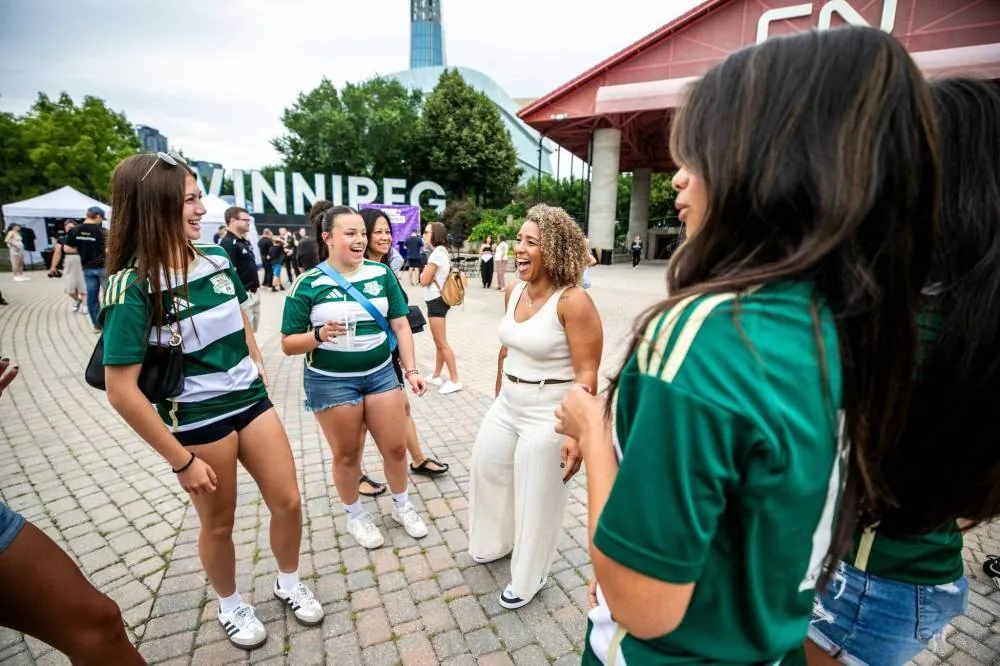 MIKAELA MACKENZIE / FREE PRESS NSL Winnipeg expansion team co-founder Desiree Scott (right) laughs with FC Northwest League U17 girls players Bre Horn (left) and Lyla Lagimodiere at The Forks on Tuesday.